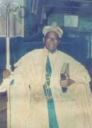 Celestial Church of Christ leader in white robe holding scriptures